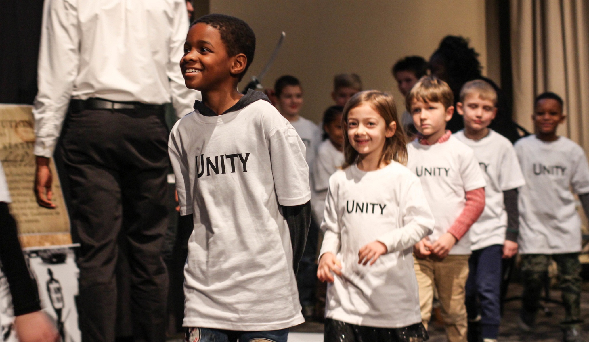 five children in a line wearing Unity tee shirts 