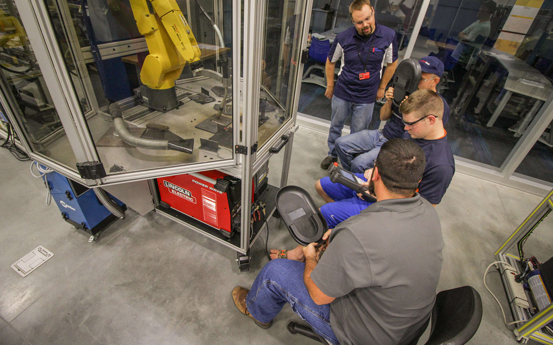 Students and instructor working with the FANUC robot