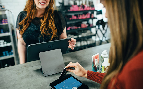 Credit card transaction with smiling sales associate