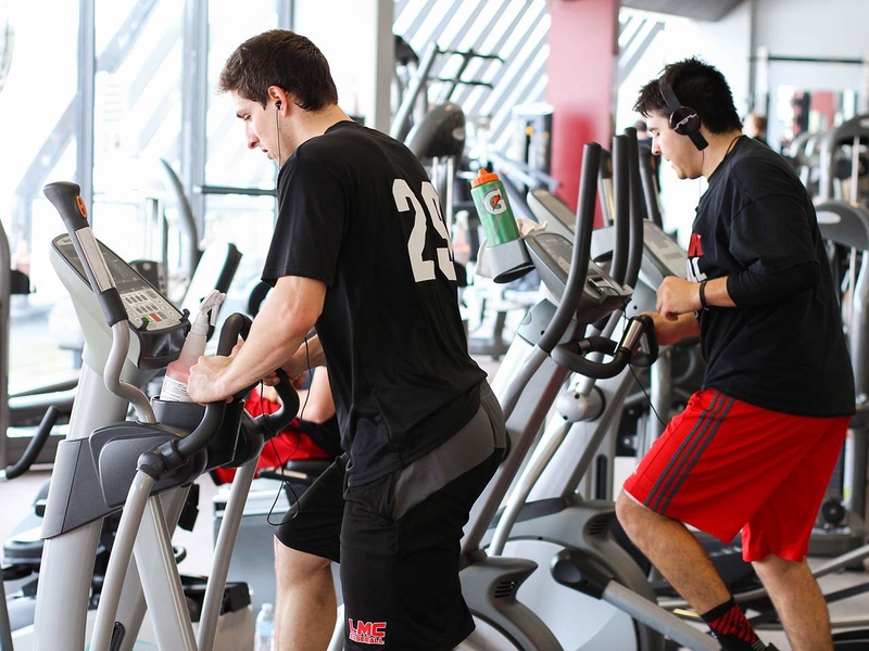 Students working out on a Stairmaster in Wellness Center