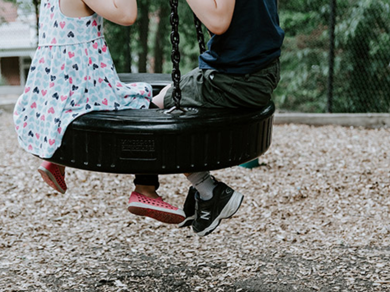 Children playing on a tire swing