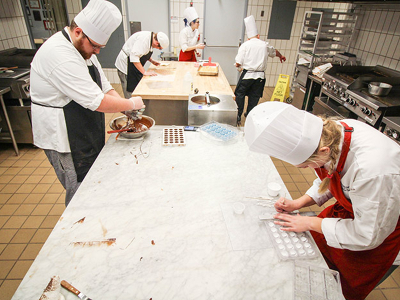 Students working with chocolate in the teaching kitchen.