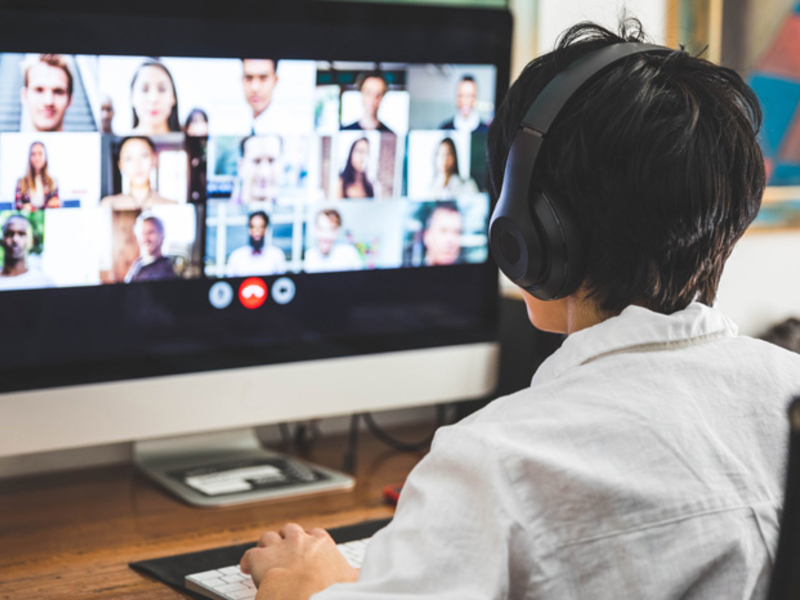 Person wearing a headset participates in a virtual meeting.