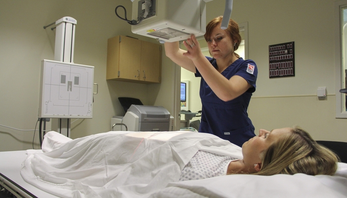 Rad tech student practicing in x-ray lab