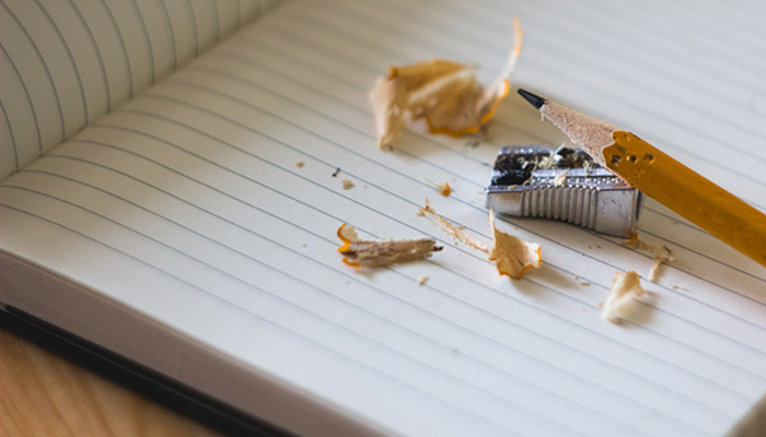 Pencil and sharpener on a blank journal