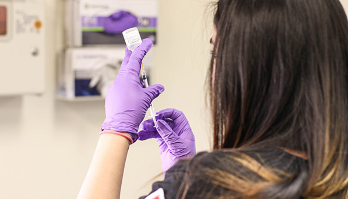 Student preparing a needle