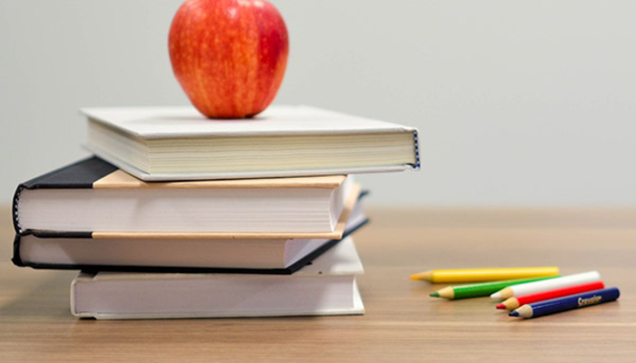 Apple with books on a desk