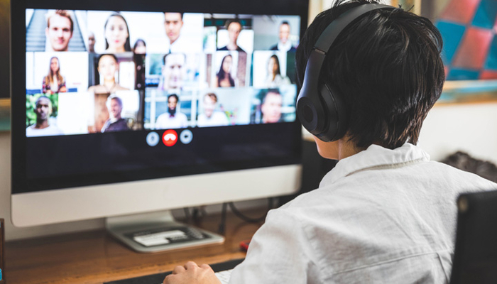 Person wearing a headset participates in a virtual meeting.