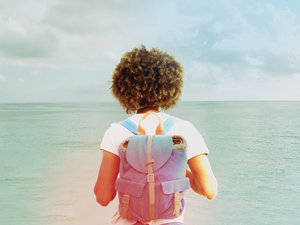 Woman with backpack looking toward the horizon
