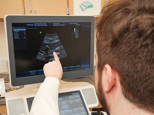Sonography student studies ultrasound image