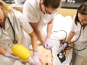 Nursing students practice CPR during class