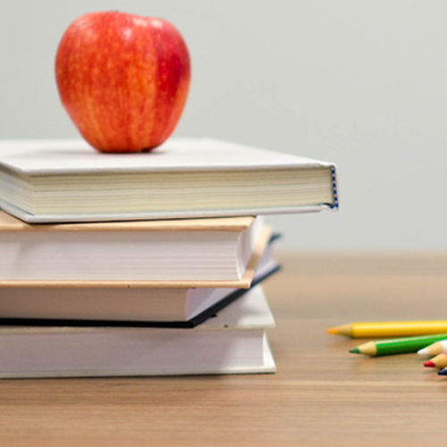 Apple with books on a desk